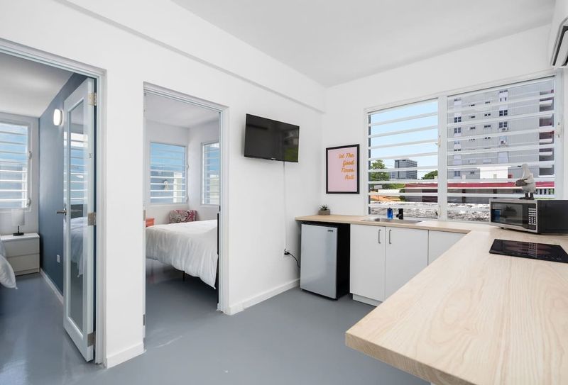 Condado | Near The Beach Condo 3 The juxtaposition of modern interiors with views of natural greenery offers guests a serene yet contemporary living experience.