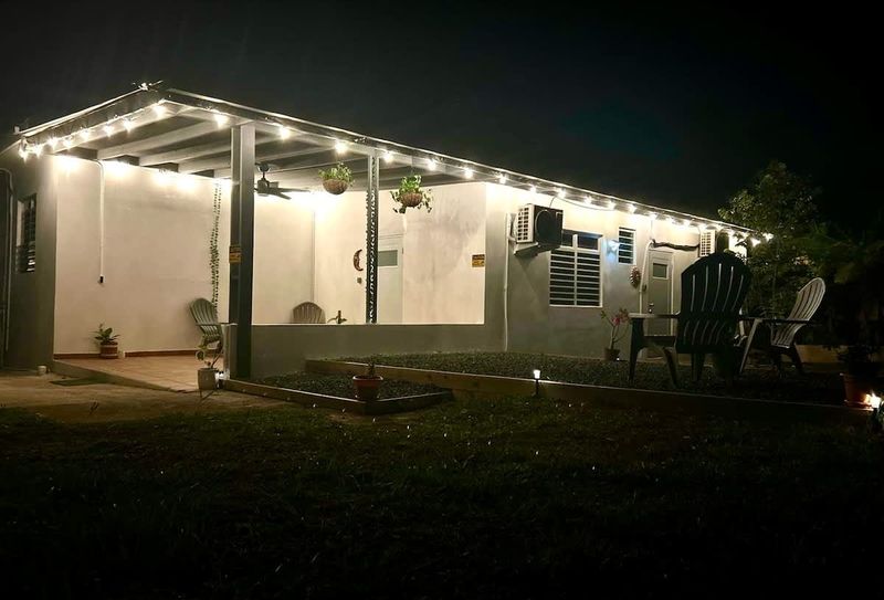 Cozy countryside escape lit up at night—enjoy quiet conversations under the string lights or stargaze from the Adirondack chairs. Your peaceful stay at Casa Natura begins here.
