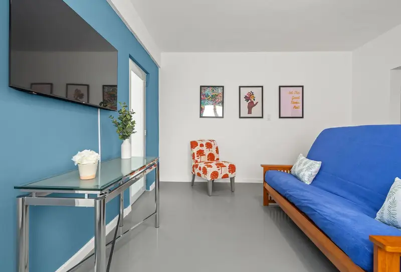 Living room with smart TV and futon for two