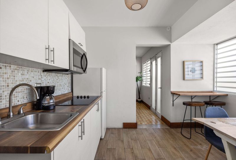 Miramar Groups Apartment 2 Modern kitchen with wood counters