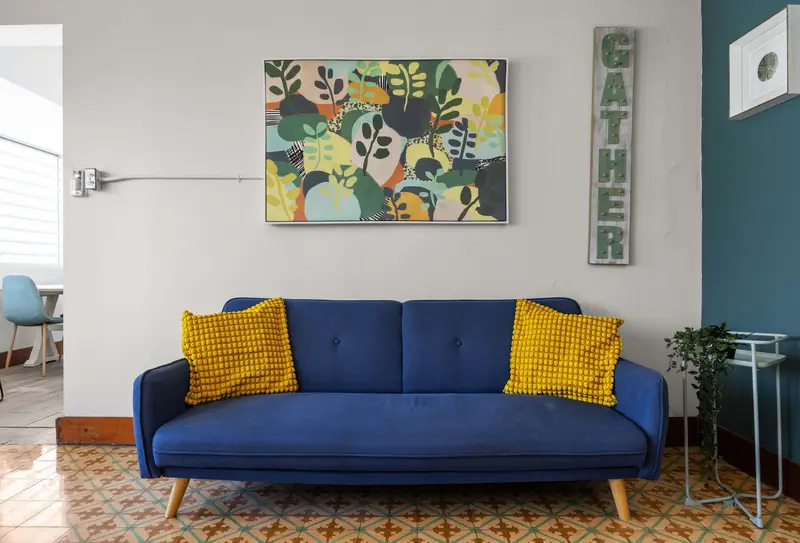 T-Mobile District | 3BR Apartment | San Juan 5 Blue sofa and wall decor