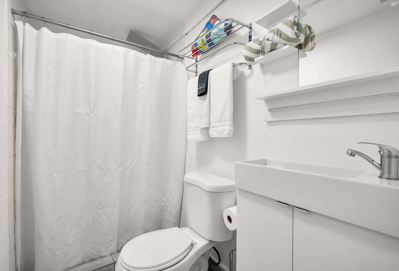 Slide open the architectural barn doors to reveal a clean, modern en-suite bathroom. Seamless privacy just steps from your bed.