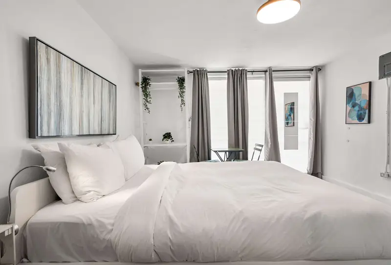 Miramar | Studio | T-Mobile 5 Unwind in a sleek, open-concept studio. Enjoy a plush queen bed right next to your private, fully equipped kitchenette—perfect for seamless urban living.