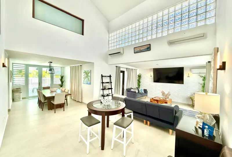 Private Pool | Steps to Beach | Gated Golf Resort 5 Bright double-height living room with A/C