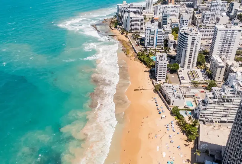 Condado 2BR for 6 | Living Room | 6-Min to Beach 5 Aerial view of Condado Beach, a 6-minute walk from the apartment