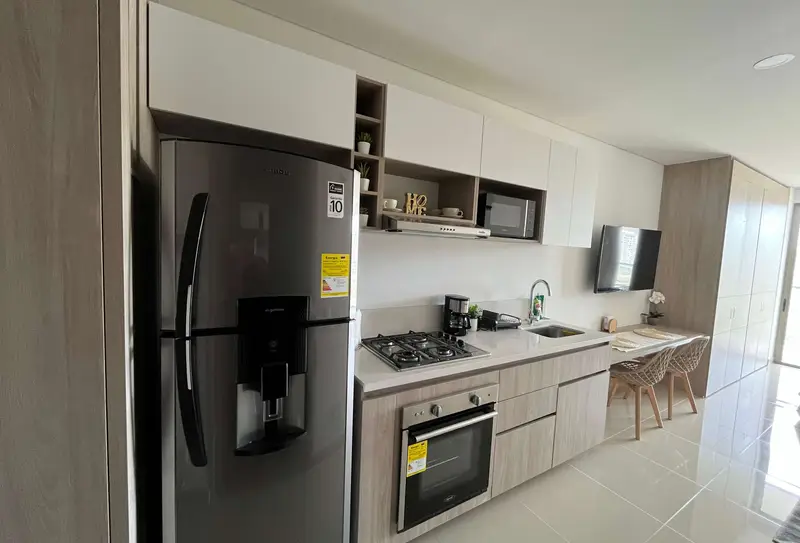Kitchen with fridge, oven, gas stove and microwave