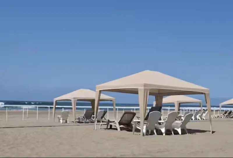 Private beach with shaded cabanas