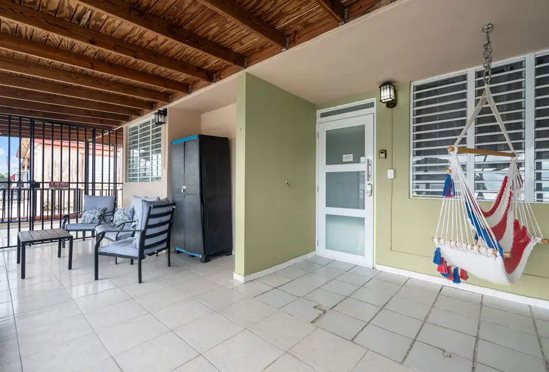 Covered terrace with seating and hanging hammock chair