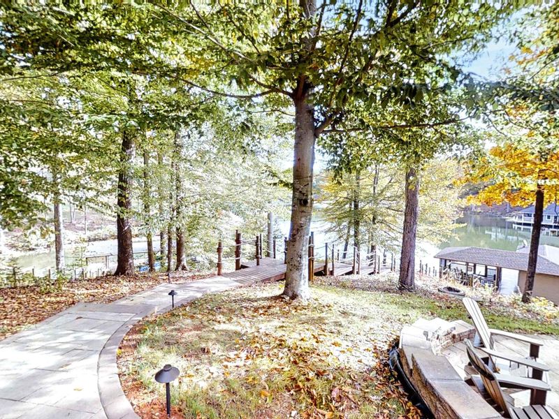 Stroll down this scenic, tree-lined pathway leading to the dock, where you can enjoy tranquil lake views and ultimate relaxation.