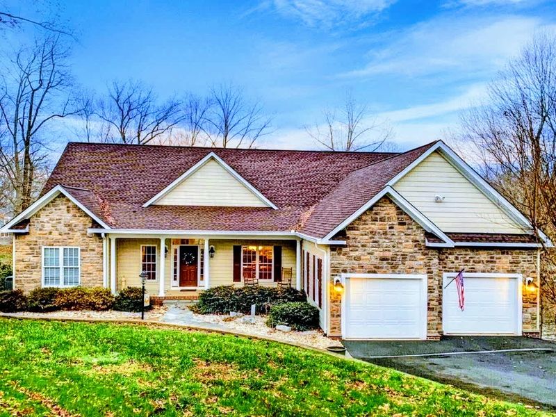 Escape to this stunning lakefront home, featuring charming stone accents, a spacious layout, and a peaceful setting perfect for a relaxing getaway.