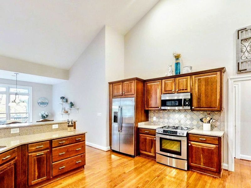 Enjoy cooking with ease in this fully equipped kitchen featuring stainless steel appliances, a spacious layout, and elegant cabinetry that blends functionality with warmth.