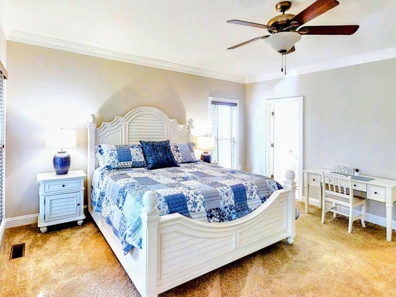 Retreat to this spacious and elegantly designed Primary Bedroom, featuring a plush king bed, private deck access, and an en suite bathroom for ultimate comfort and convenience.