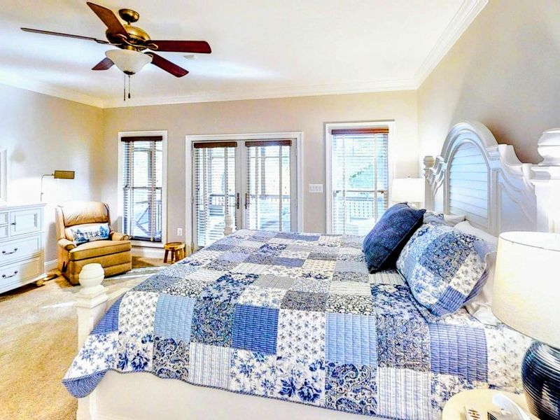 Retreat to this spacious and elegantly designed Primary Bedroom, featuring a plush king bed, private deck access, and an en suite bathroom for ultimate comfort and convenience.