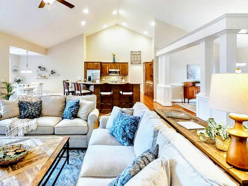 Indulge in a spacious and elegantly designed lakefront retreat, featuring cozy seating, high ceilings, and a seamless open floor plan perfect for gatherings.