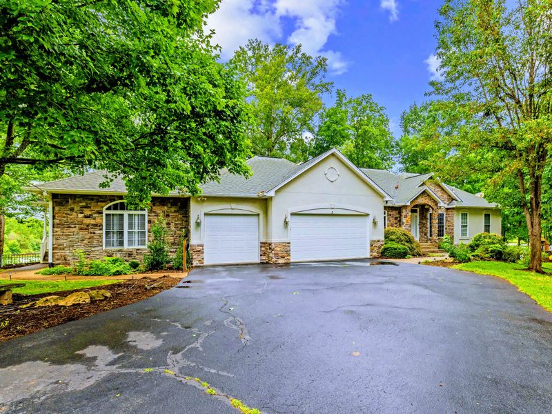 Welcome to Ruth Estate, a classic lakefront home set on a private, wooded lot at Lake Anna.