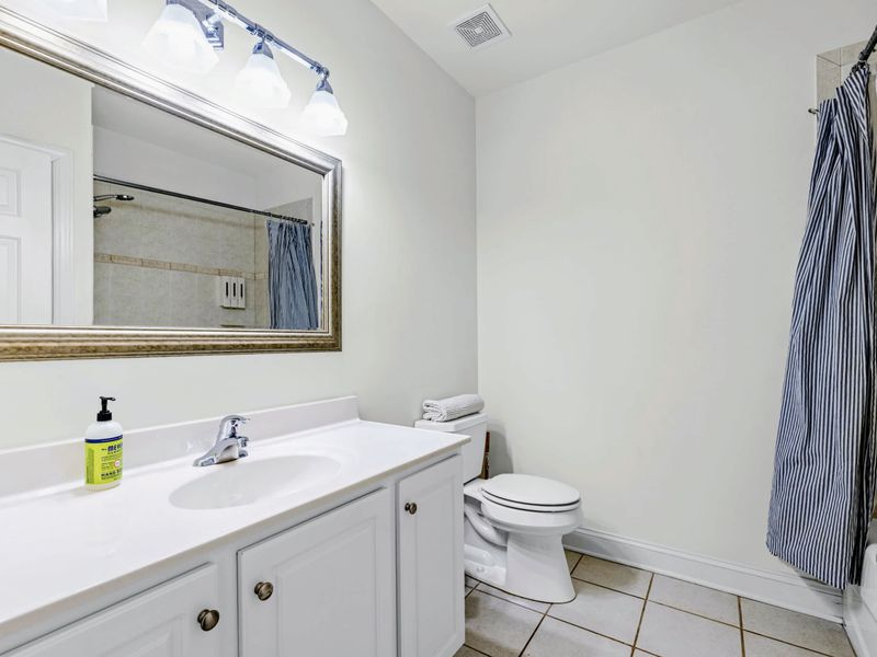 A full shared bathroom with tub-shower combo, convenient to the lake-level bedrooms.