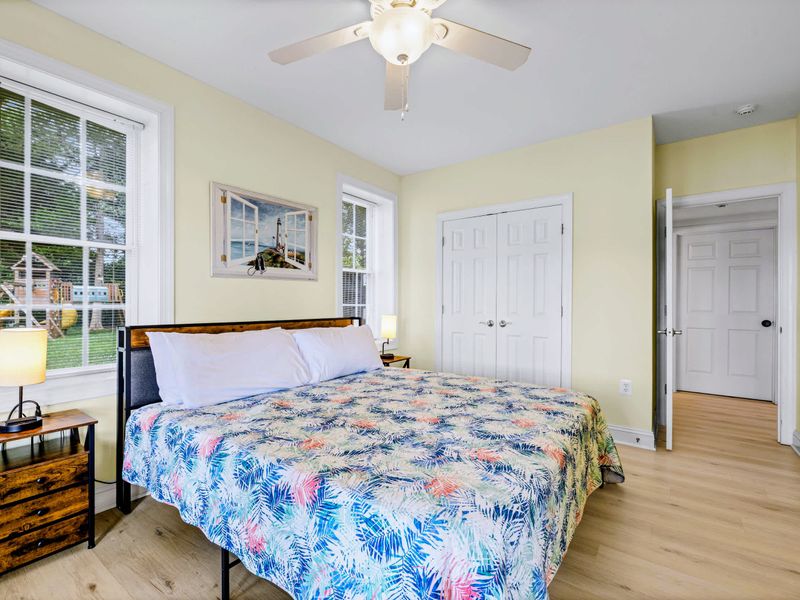 A sunny king bedroom steps from the lower-level living space and lake.