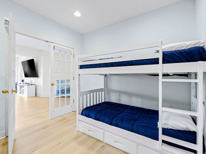 Bunk beds make this the room the kids will fight over, right by the playroom.