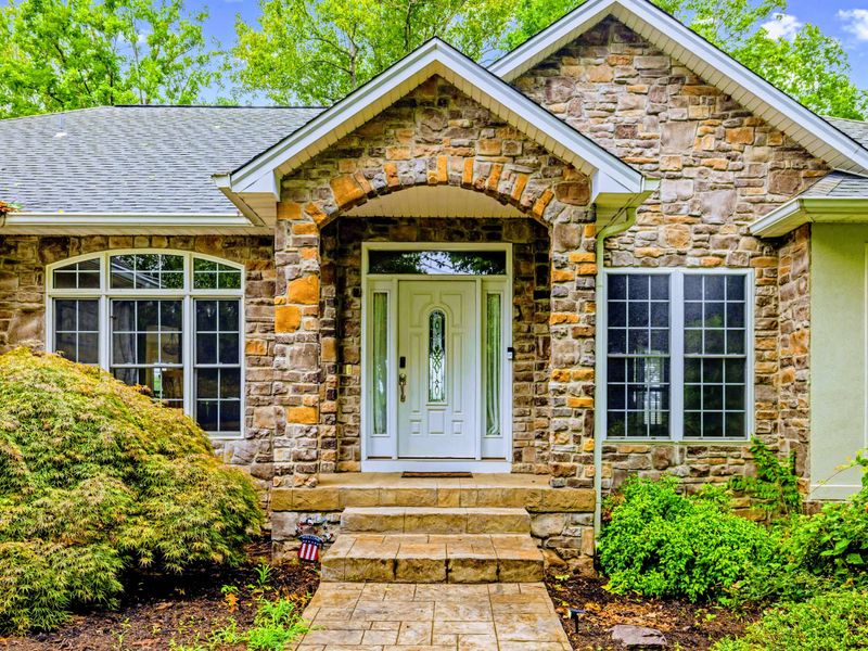 Craftsman stonework and a welcoming porch set the tone before you even step inside.