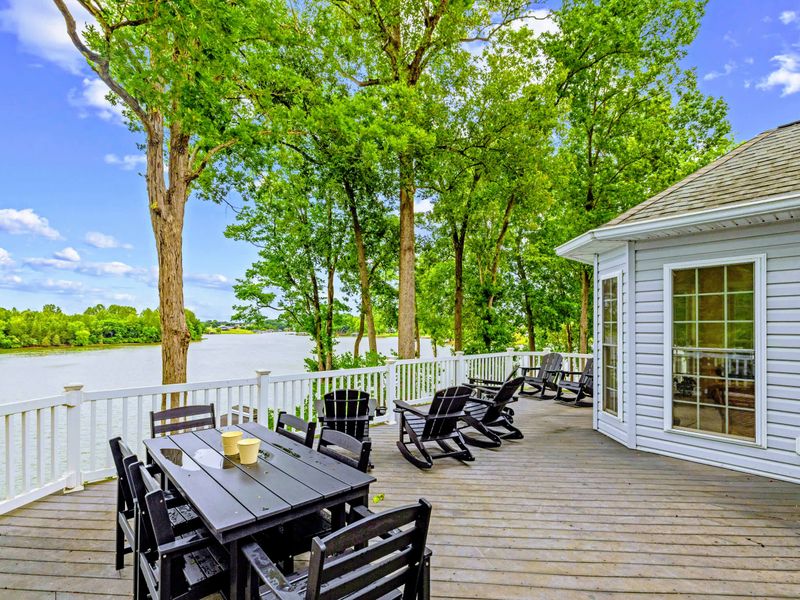 The main deck stretches across the back of the home with sweeping lake views.