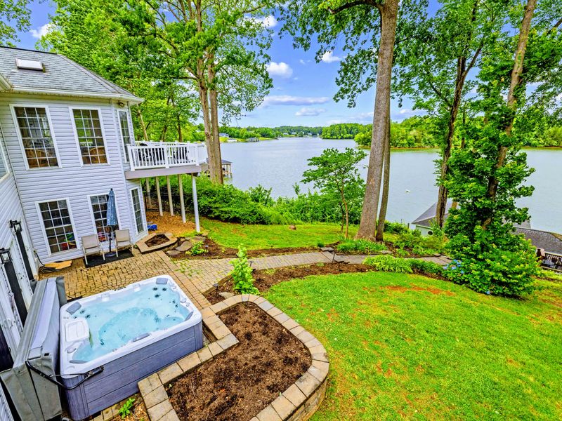 Tiered backyard and decks lead down toward the shoreline.