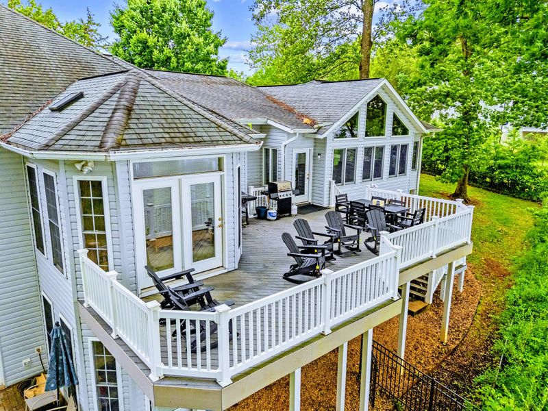 A covered porch area offers shade and a swing just off the deck.
