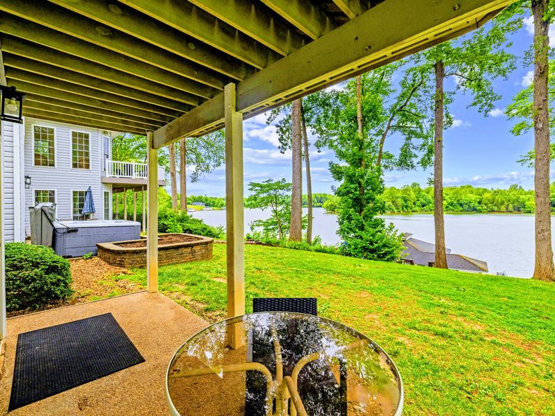 A covered lower patio with a fire feature for cool lake evenings.