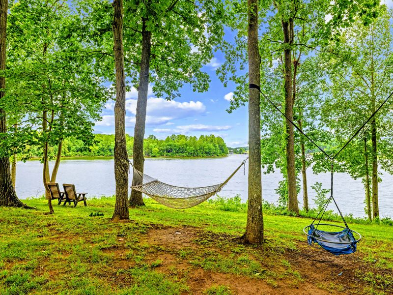 A shady hammock invites an afternoon nap by the lake.
