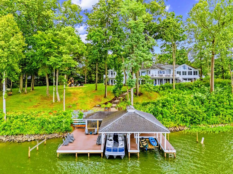From above: the full property's lakefront position, private dock, and tiered yard down to the water.