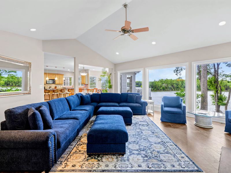 Vaulted ceilings and lake-facing windows fill the great room with light.