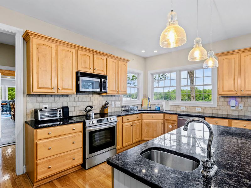 The kitchen opens to the dining and living areas for true open-concept living.
