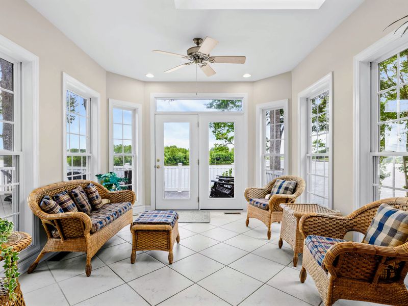 The lounge end of the sunroom, an inviting spot to relax under the vaulted ceiling.
