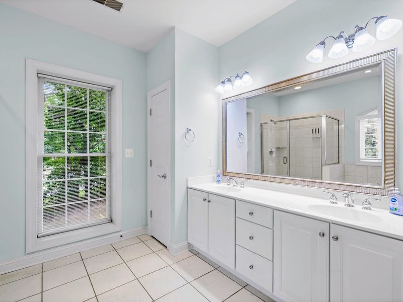 Double vanities and a spa feel make the primary bath a retreat of its own.