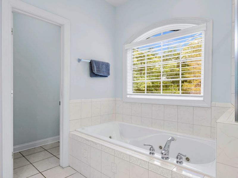 Glass shower and generous counter space in the primary bath.