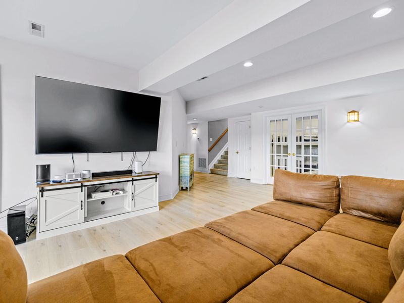 The lower level keeps the whole group entertained, steps from the backyard and water.