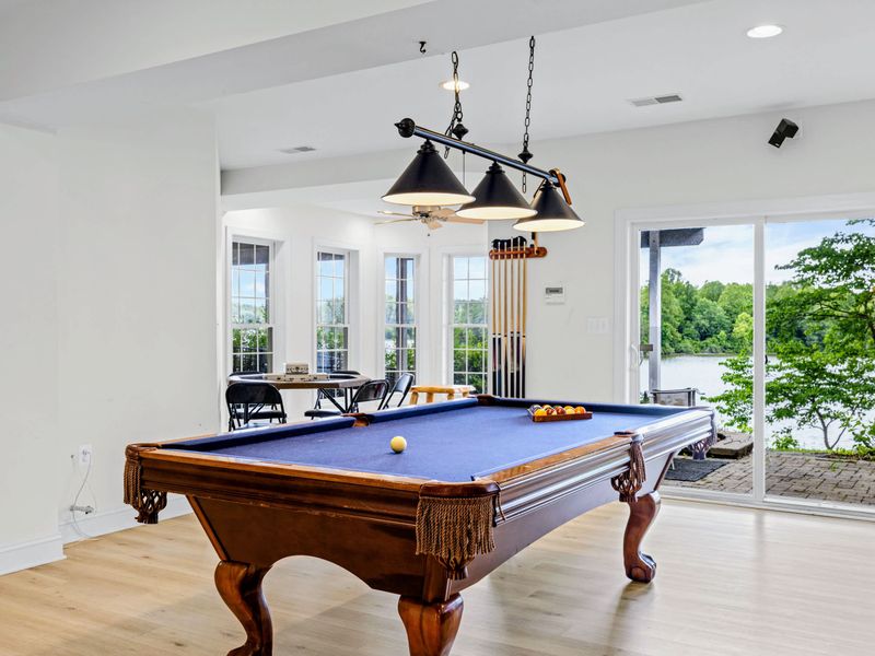Pool table with lake views, the energy keeps going long after sunset.