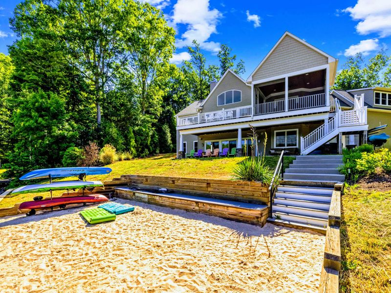 Backyard - The lawn rolls gently down to the shoreline, kayaks racked and ready with the lake just a few steps away.