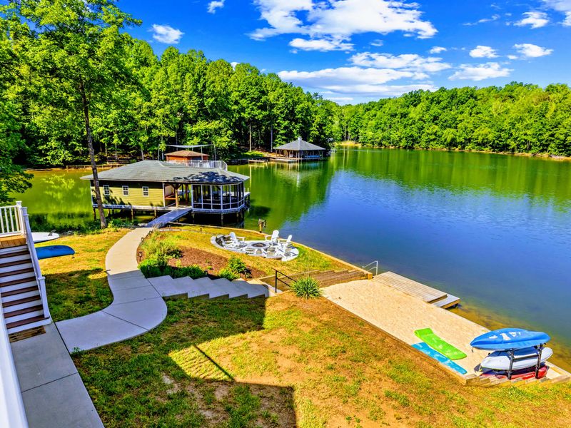 Aerial View - An elevated look at the decks, yard, and private dock reaching into the calm Lake Anna cove.