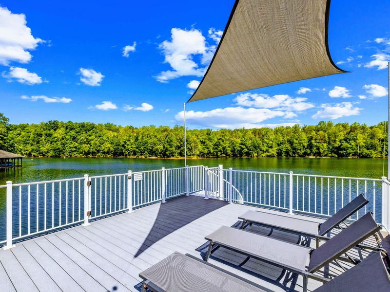 Dock Sun Deck - A breezy perch above the water, loungers and white railings framing the open lake.