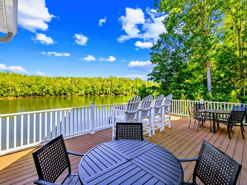 Upper Deck - Lakeside dining along the white railing, the water stretching out past the deck's edge.