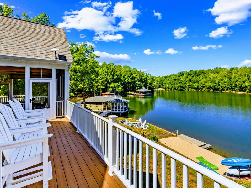 Upper Deck - White Adirondack chairs face the water from the composite deck, ready for morning coffee or golden hour.