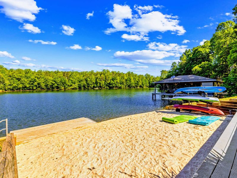 Sandy Beach - Soft sand, calm water, and the dock just beyond make this the family's home base all summer long.