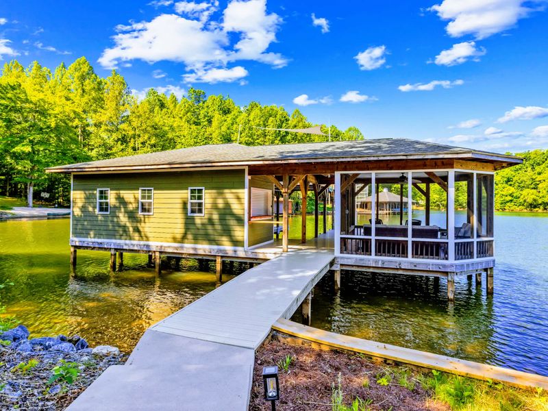 Boathouse - The charming green boathouse and screened porch sit out over the water, reached by a private walkway from shore.