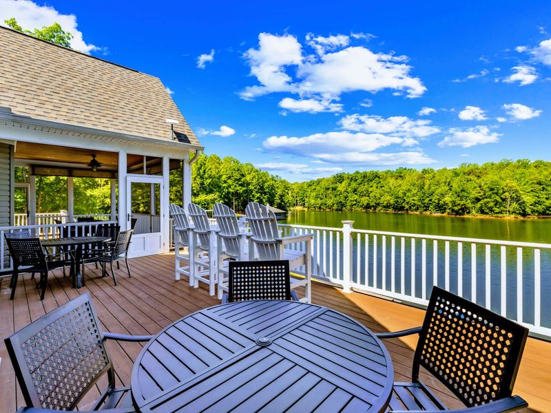 Upper Deck - Room to dine and lounge in the open air, with Adirondack chairs angled toward the lake.