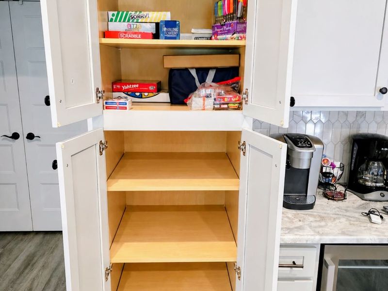 Game Cabinet - A stocked cabinet of board games for cozy evenings in.