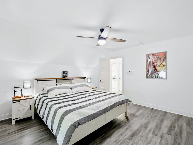 Bedroom - Farmhouse headboard, matching nightstands, and big windows in this comfortable king room.