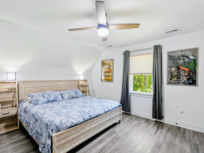 Bedroom - Gray-wash king bed framed by windows, a restful retreat after a day outdoors.