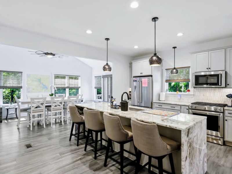 Kitchen - Bar stools line the oversized island, the natural gathering spot while meals come together.
