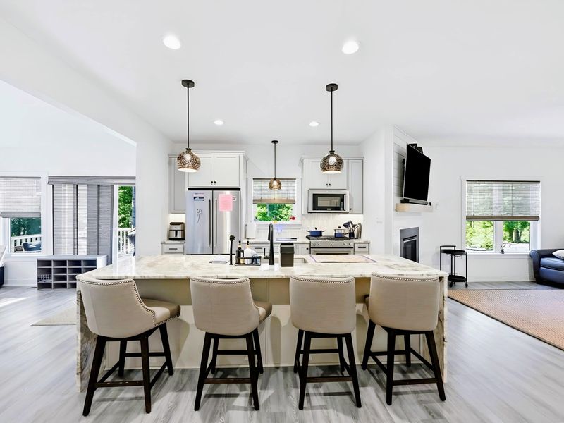 Kitchen - Full-size stainless refrigerator and ample prep space, stocked for cooking on vacation.