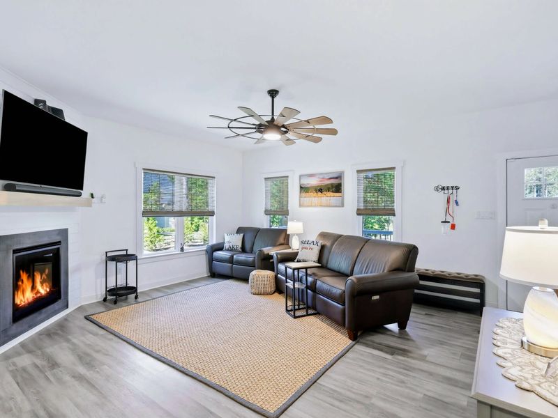 Living Room - Leather sectional, gas fireplace, and wall-mounted TV in an open layout made for gathering.